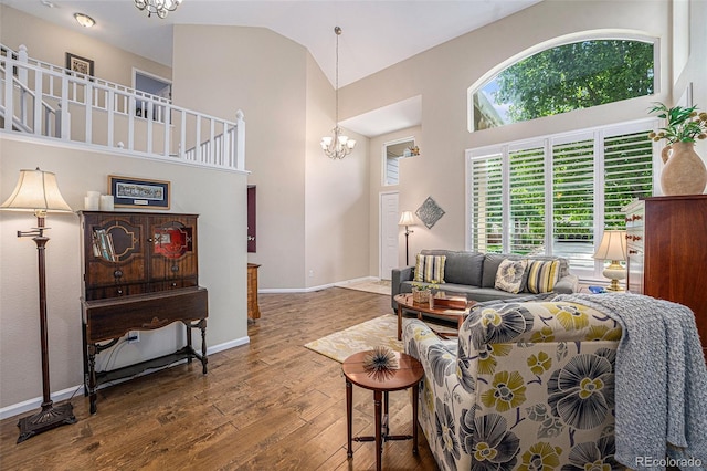6836 Poppy Ct, Arvada, CO 80007 - living room with hardwood / wood-style flooring, a chandelier, and high vaulted ceiling