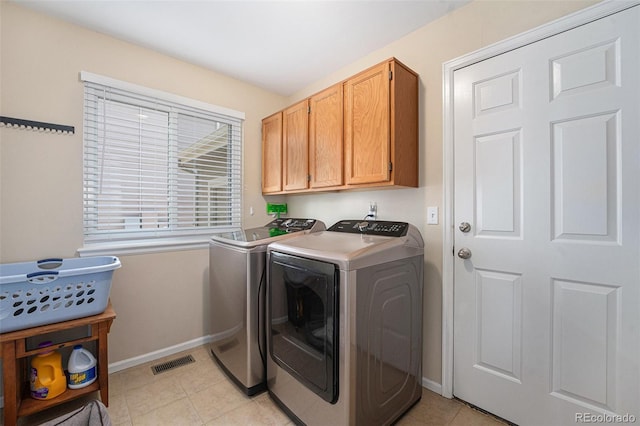 6836 Poppy Ct, Arvada, CO 80007 - laundry room with washer and dryer, cabinet space, and light tile patterned floors