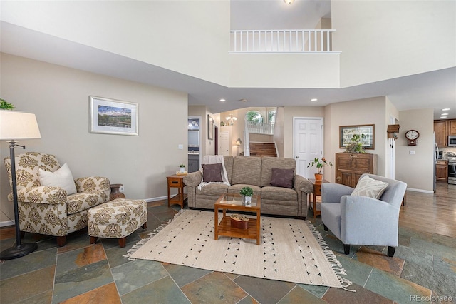6836 Poppy Ct, Arvada, CO 80007 - living room featuring recessed lighting, dark stone finish flooring, and a high ceiling