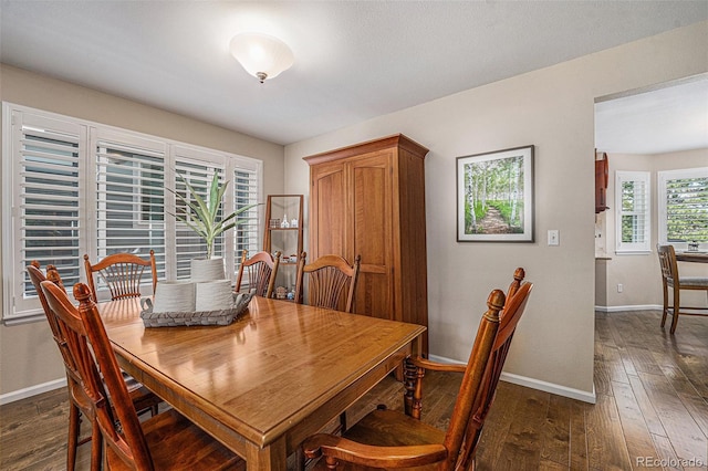 6836 Poppy Ct, Arvada, CO 80007 - dining room featuring dark wood-type flooring and baseboards