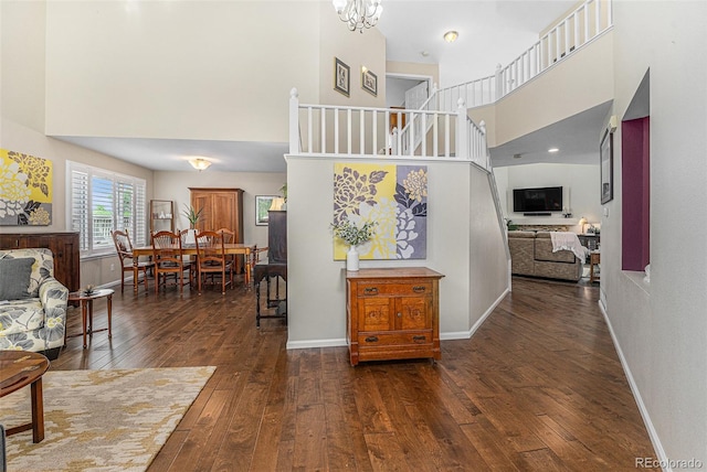 6836 Poppy Ct, Arvada, CO 80007 - staircase with a high ceiling, hardwood / wood-style flooring, and a chandelier