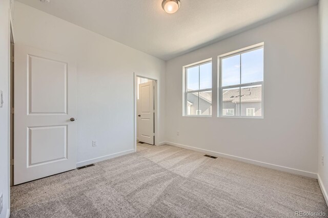 1974 S Haleyville Way, Aurora, CO 80018 - unfurnished bedroom featuring baseboards, light carpet, and multiple windows