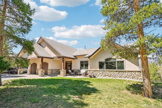 50 Spinning Leaf Trl, Silverthorne, CO 80498 - back of property with stone siding, stucco siding, an attached garage, and a yard