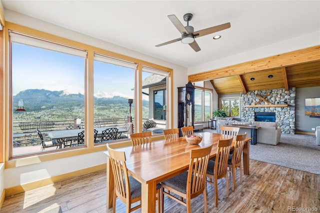 50 Spinning Leaf Trl, Silverthorne, CO 80498 - dining area with a stone fireplace, a mountain view, a ceiling fan, light wood-style floors, and recessed lighting