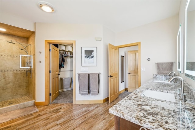50 Spinning Leaf Trl, Silverthorne, CO 80498 - full bath with wood finished floors, double vanity, tiled shower, and baseboards