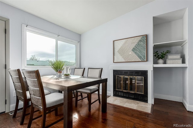 1451 S Quitman St, Denver, CO 80219 - dining area featuring wood finished floors, a fireplace with flush hearth, and baseboards