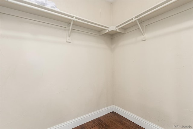 1451 S Quitman St, Denver, CO 80219 - spacious closet featuring dark wood-type flooring