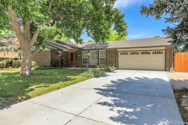 6425 W Frost Dr, Littleton, CO 80128 - single story home with a garage, brick siding, and driveway