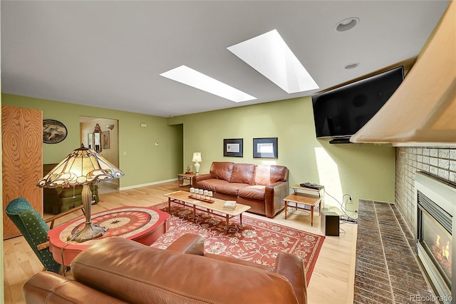 6425 W Frost Dr, Littleton, CO 80128 - living room featuring a skylight, wood finished floors, and a brick fireplace