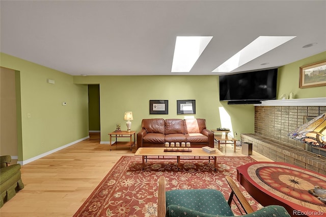 6425 W Frost Dr, Littleton, CO 80128 - living room with wood finished floors, a brick fireplace, and a skylight