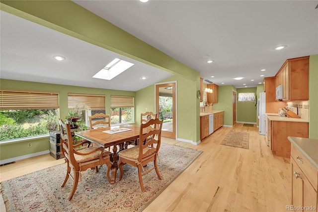 6425 W Frost Dr, Littleton, CO 80128 - dining room with a skylight, light wood finished floors, plenty of natural light, recessed lighting, and vaulted ceiling