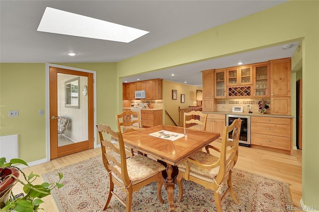 6425 W Frost Dr, Littleton, CO 80128 - dining space featuring beverage cooler, light wood finished floors, recessed lighting, and a bar