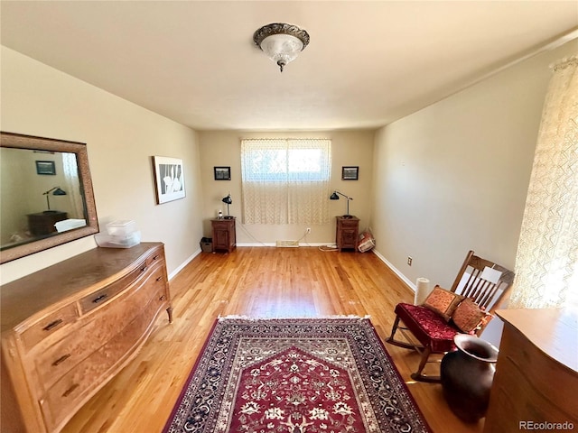 living area featuring light wood-style flooring and baseboards