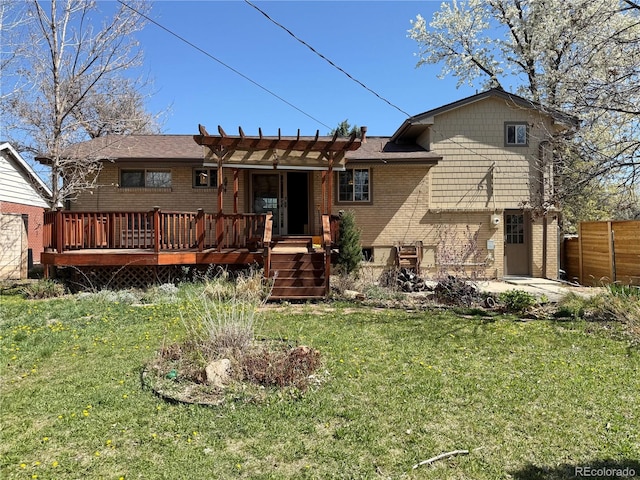 back of property featuring a deck, a pergola, a lawn, fence, and brick siding