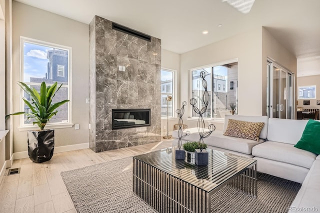 1764 Peak Loop, Broomfield, CO 80023 - living room featuring wood finished floors, baseboards, a high end fireplace, and recessed lighting