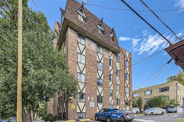 1008 N Corona St Unit 403, Denver, CO 80218 - view of apartment building / complex featuring uncovered parking