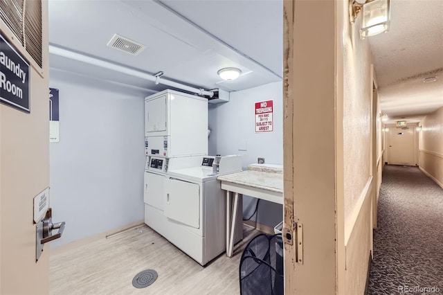 1008 N Corona St Unit 403, Denver, CO 80218 - community laundry room with estacked washer and dryer, light wood-type flooring, and washer and clothes dryer