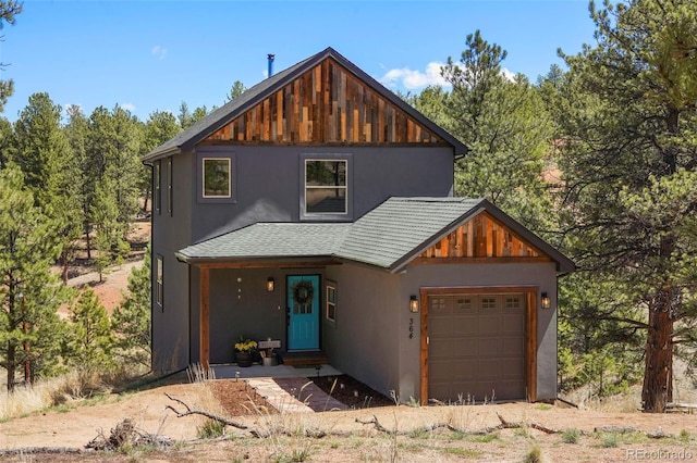 364 Phoebus Dr, Florissant, CO 80816 - view of front of home with stucco siding, a garage, and a shingled roof
