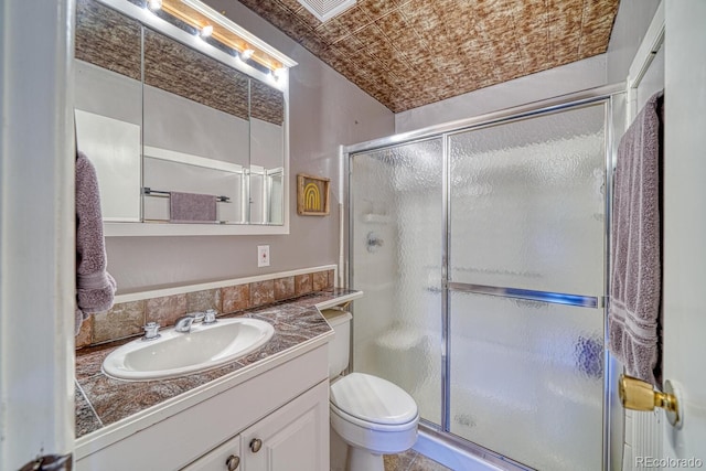 full bath featuring vanity, a stall shower, toilet, visible vents, and an ornate ceiling