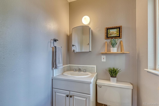 half bath featuring toilet and vanity