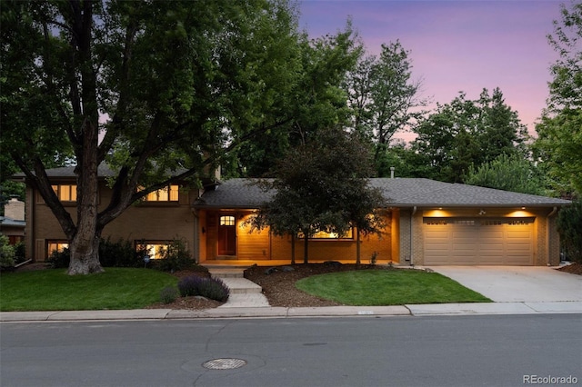3190 S Detroit St, Denver, CO 80210 - view of front of house with a garage, concrete driveway, a yard, and brick siding