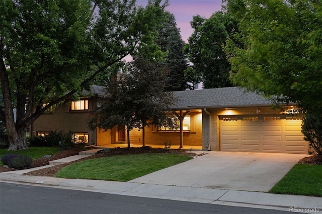 3190 S Detroit St, Denver, CO 80210 - view of front facade with a garage, brick siding, a front lawn, and concrete driveway
