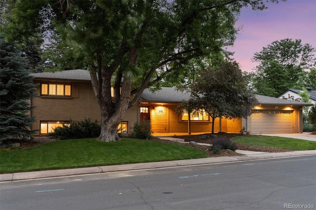 3190 S Detroit St, Denver, CO 80210 - view of front of house with a garage, a front yard, concrete driveway, brick siding, and a shingled roof