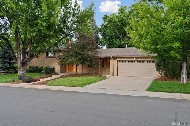 3190 S Detroit St, Denver, CO 80210 - view of front of property with an attached garage, concrete driveway, a chimney, and a front yard