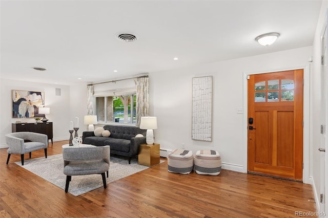 3190 S Detroit St, Denver, CO 80210 - living room with wood finished floors, baseboard heating, and recessed lighting