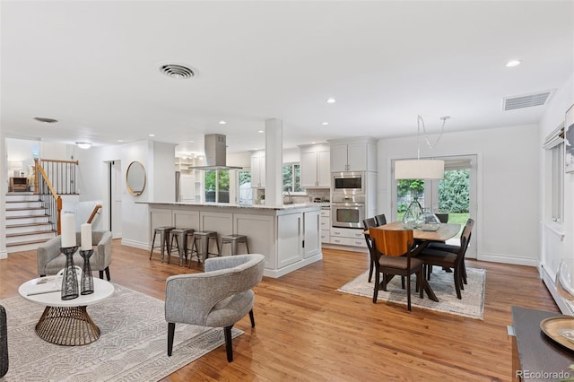 3190 S Detroit St, Denver, CO 80210 - living room featuring light wood-style flooring, stairs, and recessed lighting