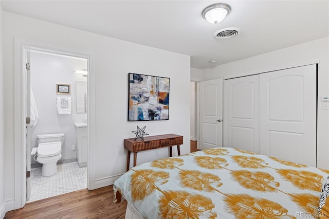 3190 S Detroit St, Denver, CO 80210 - bedroom featuring a closet, wood finished floors, and connected bathroom