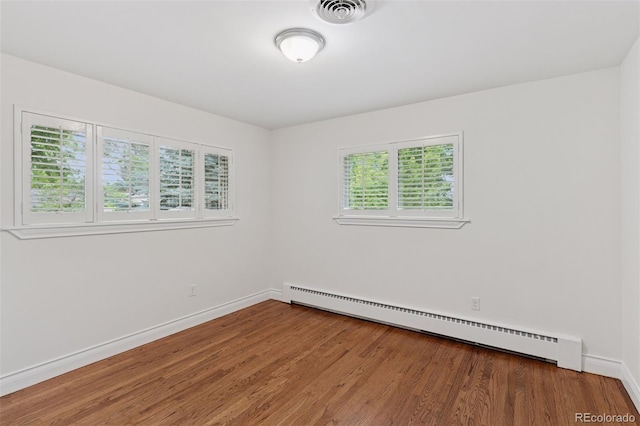 3190 S Detroit St, Denver, CO 80210 - spare room featuring a baseboard heating unit and wood finished floors