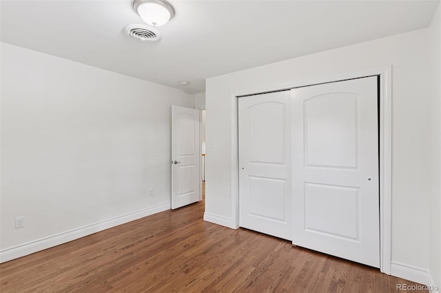 3190 S Detroit St, Denver, CO 80210 - unfurnished bedroom with wood finished floors and a closet