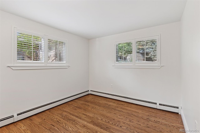 3190 S Detroit St, Denver, CO 80210 - spare room featuring healthy amount of natural light, wood finished floors, and a baseboard heating unit