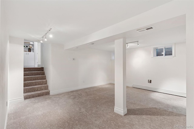 3190 S Detroit St, Denver, CO 80210 - finished below grade area with rail lighting, a baseboard radiator, carpet flooring, and stairway