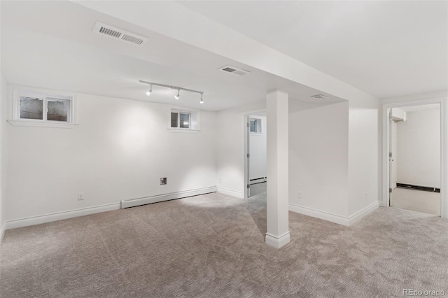 3190 S Detroit St, Denver, CO 80210 - finished basement with a baseboard radiator, carpet, and track lighting
