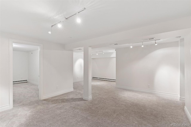 3190 S Detroit St, Denver, CO 80210 - below grade area with rail lighting, baseboard heating, and carpet flooring