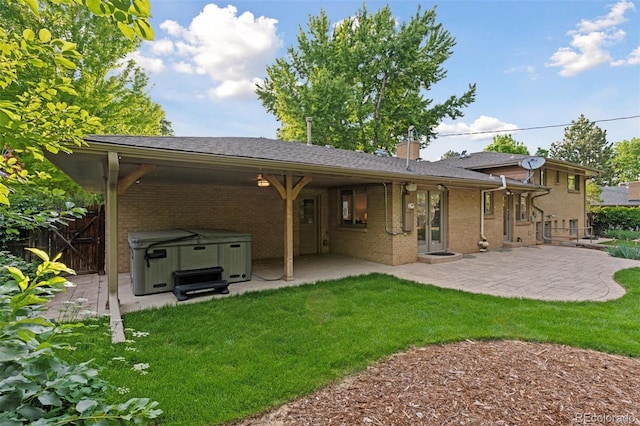 3190 S Detroit St, Denver, CO 80210 - back of property with a hot tub, a patio area, brick siding, and a chimney