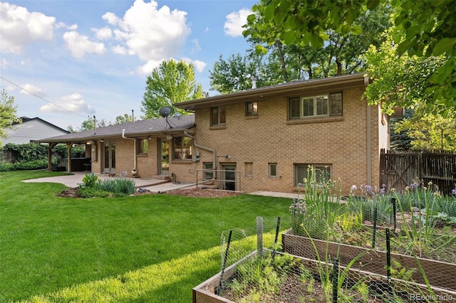 3190 S Detroit St, Denver, CO 80210 - back of house with a vegetable garden, a patio, brick siding, and an attached carport