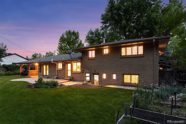 3190 S Detroit St, Denver, CO 80210 - back of house at dusk with a patio area and brick siding