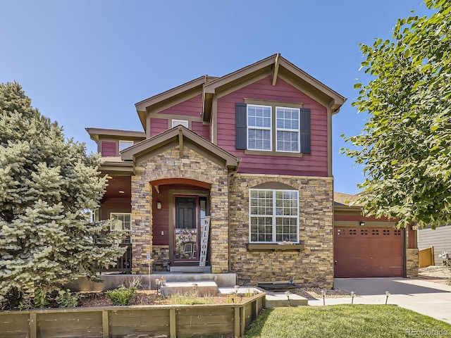 traditional home with a garage, stone siding, and driveway