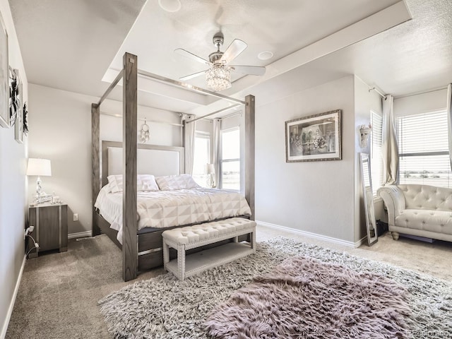 carpeted bedroom with a ceiling fan and baseboards