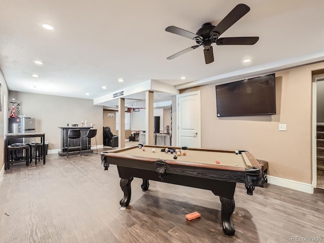 recreation room featuring light wood-style flooring, pool table, a bar, and baseboards