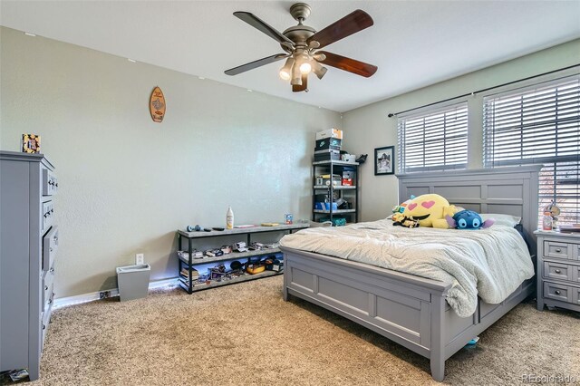 bedroom with a ceiling fan and light colored carpet