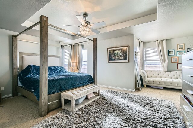 bedroom with multiple windows, a textured ceiling, baseboards, and a ceiling fan