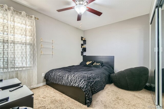 bedroom with baseboards, ceiling fan, and carpet flooring