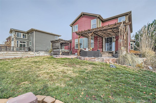 back of property featuring a yard, a patio area, and a pergola