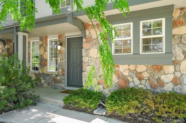 10223 Vine Ct, Thornton, CO 80229 - view of exterior entry featuring stone siding and a porch