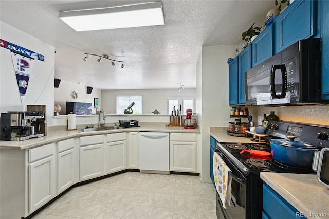 10223 Vine Ct, Thornton, CO 80229 - kitchen with black appliances, blue cabinets, light countertops, a textured ceiling, and white cabinets