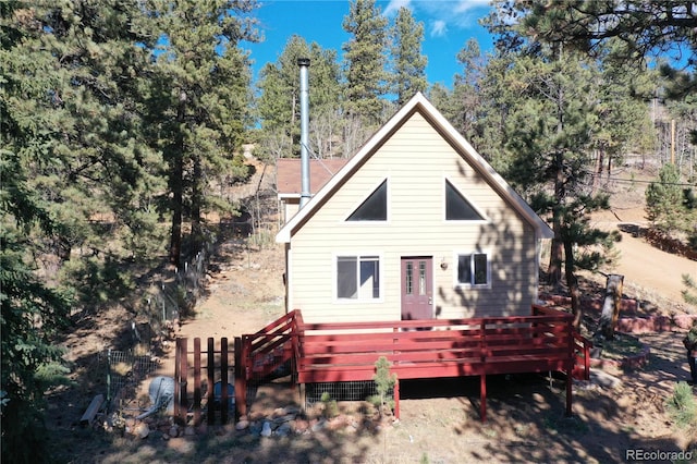 rear view of property with a wooden deck